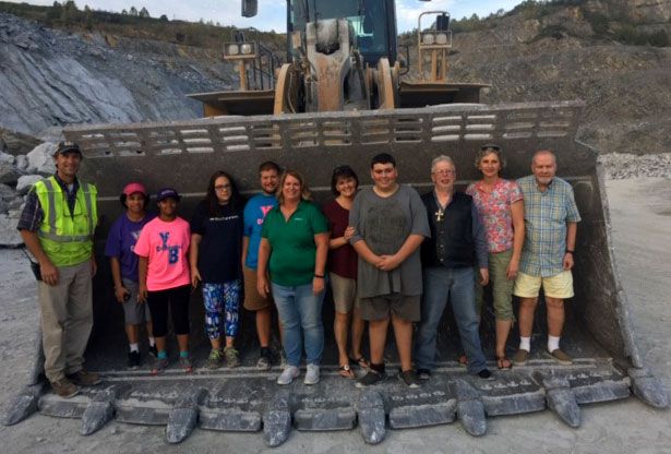 Kids and Adults Standing in Wheel Loader