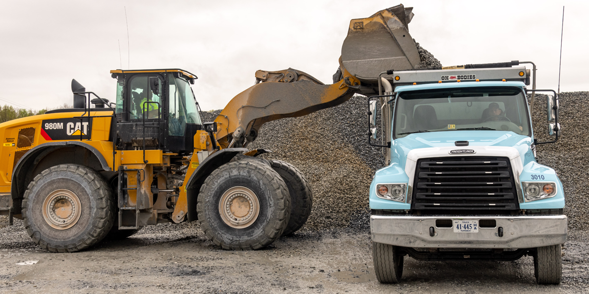 Wheel Loader Dumping Rock into Truck